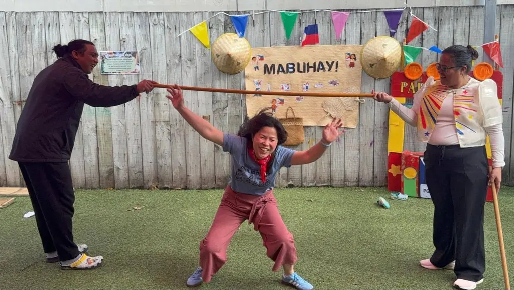 Children and kaiako taking part in a traditional game during Filipino Language Week