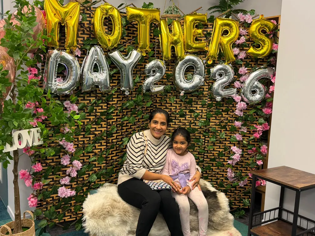 A mother and child sharing a photo together at Paramount Grove's Mother's Day celebration.