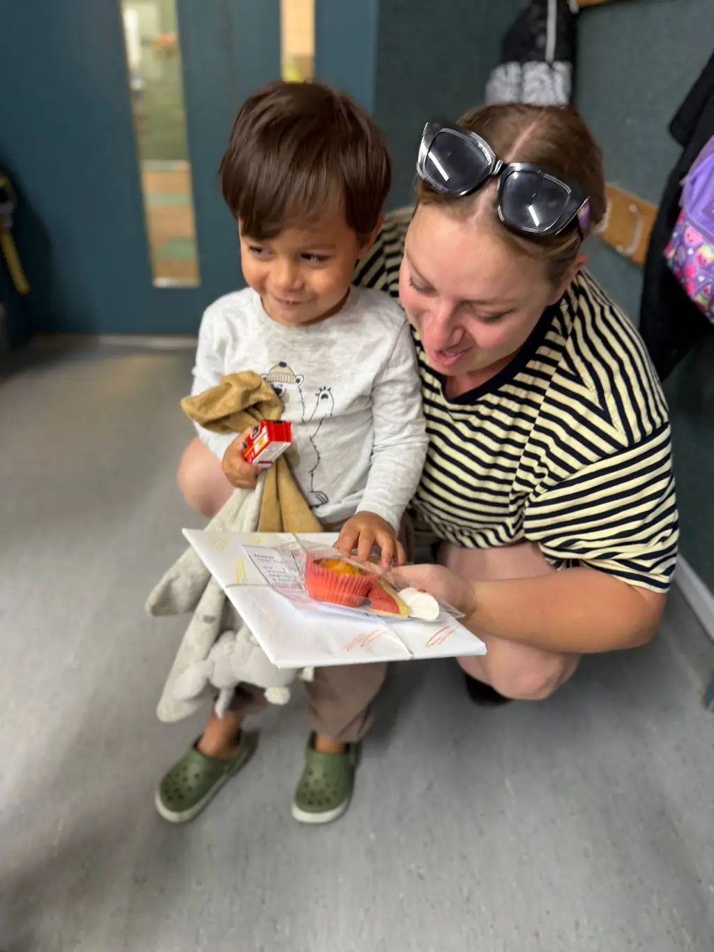 A child showing a special Mother's Day gift to a caregiver at Paramount Grove.