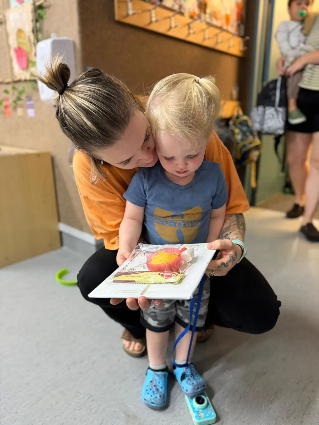 A mother and child looking together at a handmade Mother's Day card at Paramount Grove.